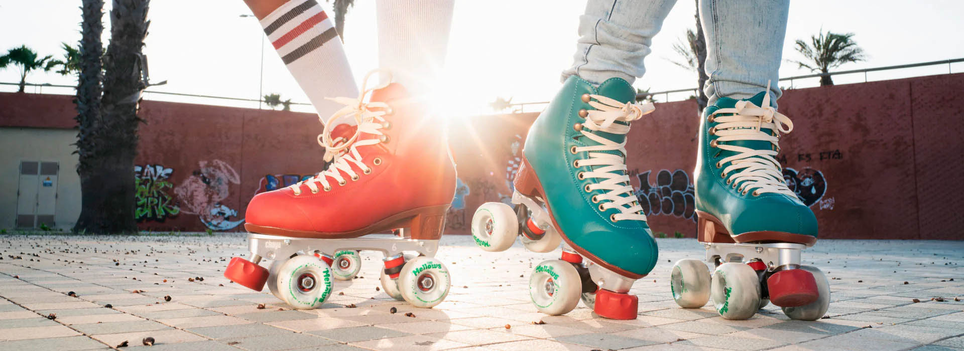 A female with long brown hair dances one roller skates and holds up one leg